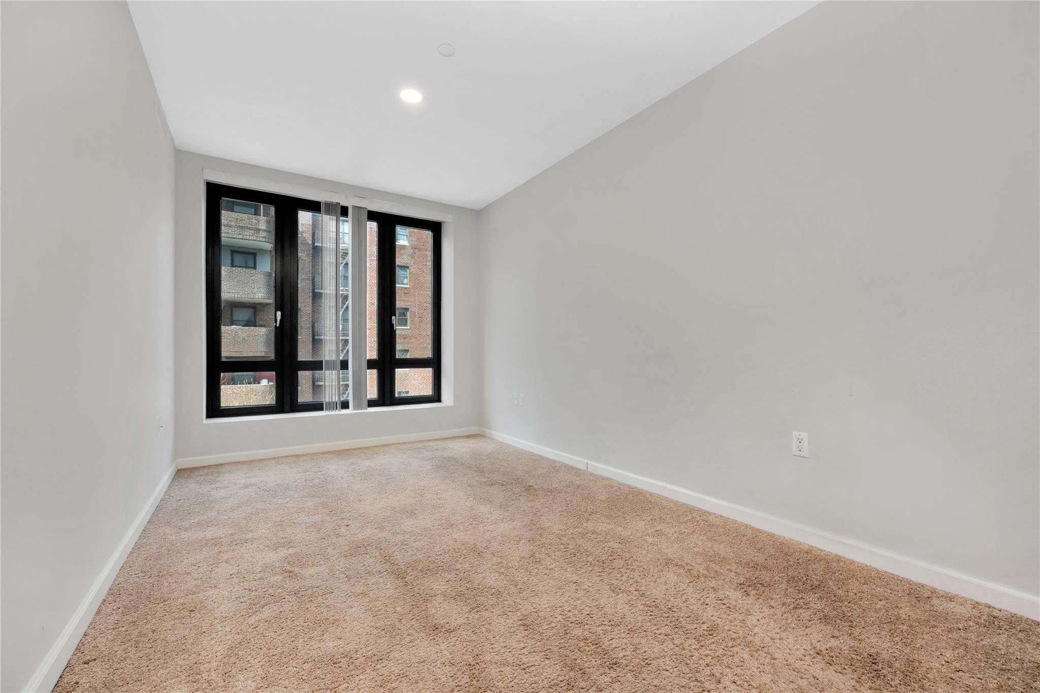 148-36 89th Avenue, Unit 3C Queens, NY 11435 - Photo 14 of 27 Spare room featuring carpet floors, baseboards, and recessed lighting