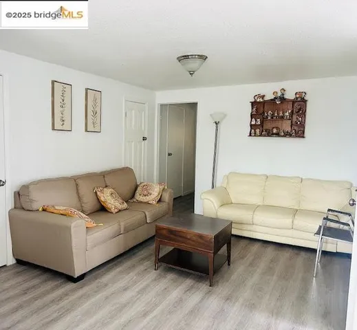 an empty room with a window and a ceiling fan