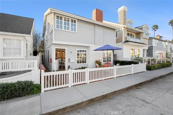 a view of a house with a yard and deck