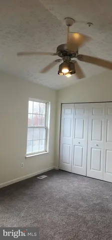 a view of an empty room and a window