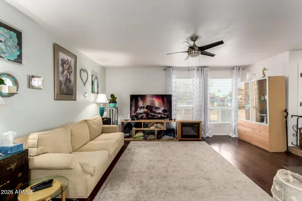 a living room with furniture a fireplace and a flat screen tv