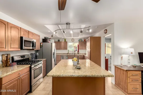 a kitchen with stainless steel appliances granite countertop a sink and a stove