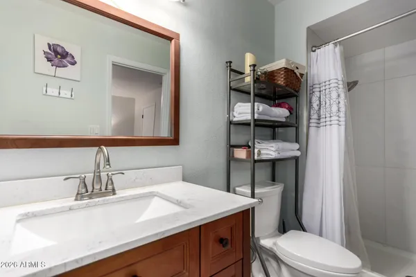 a bathroom with a sink toilet and shower