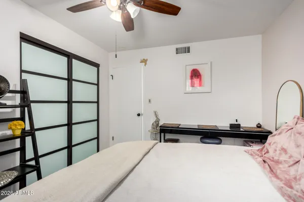 a bedroom with a bed and a chandelier