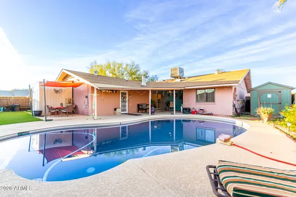 a view of a swimming pool with a lounge chair