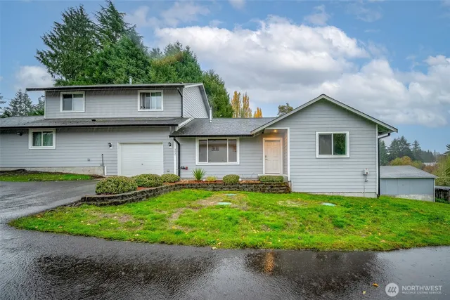 a view of a house with a yard and plants
