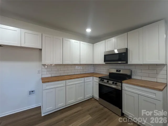 a living room with furniture a large window and a flat screen tv