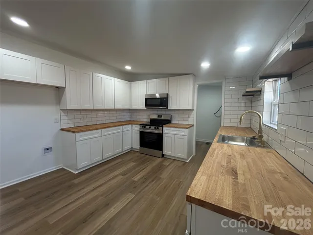 a view of a kitchen with a sink and cabinets