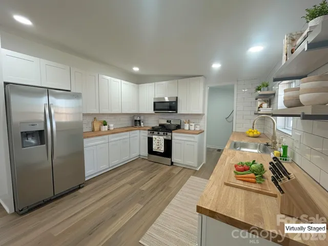 a view of empty room with wooden floor and window