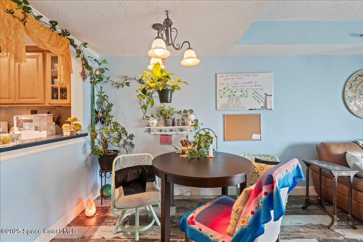 199 Florida A1A, Unit D201 Satellite Beach, FL 32937 - Photo 11 of 39 a view of a dining room with furniture and a potted plant