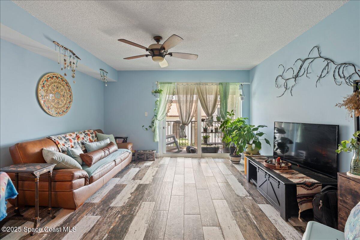 199 Florida A1A, Unit D201 Satellite Beach, FL 32937 - Photo 12 of 39 a living room with furniture and a flat screen tv