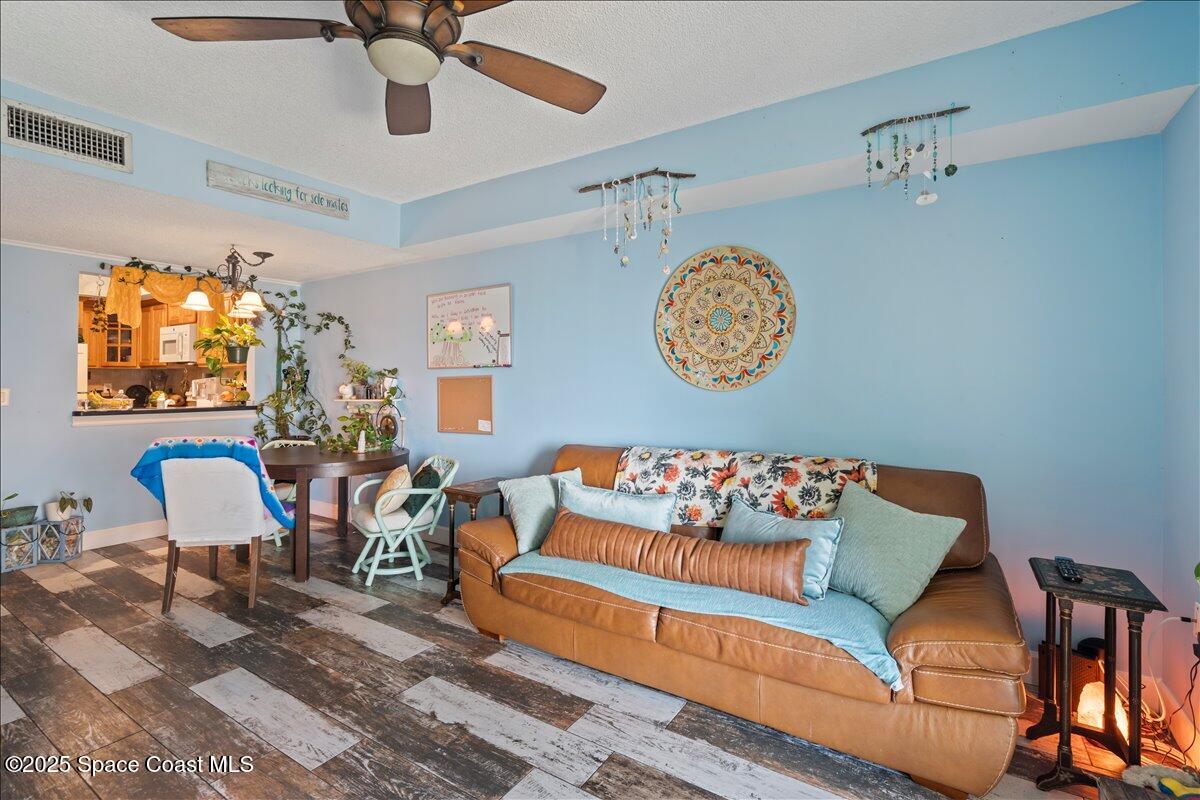 199 Florida A1A, Unit D201 Satellite Beach, FL 32937 - Photo 13 of 39 a living room with furniture and a chandelier
