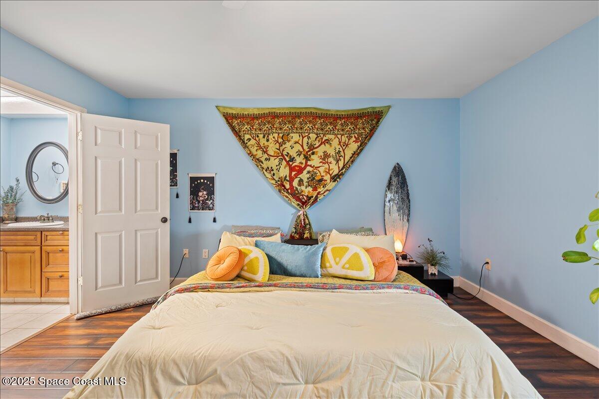 199 Florida A1A, Unit D201 Satellite Beach, FL 32937 - Photo 20 of 39 a bedroom with bed and window