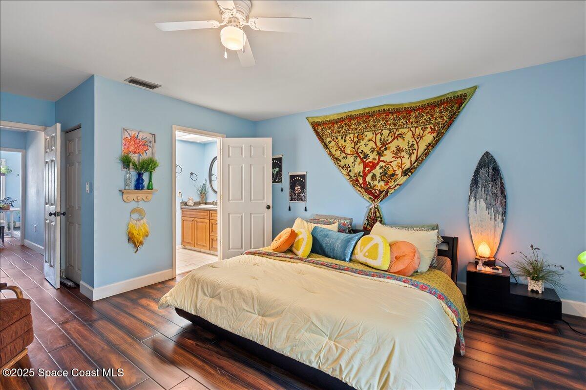 199 Florida A1A, Unit D201 Satellite Beach, FL 32937 - Photo 21 of 39 a bedroom with bed and wooden floor