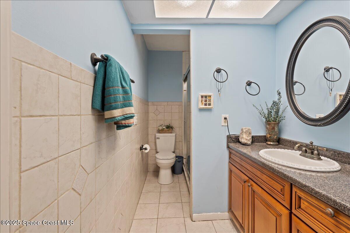 199 Florida A1A, Unit D201 Satellite Beach, FL 32937 - Photo 24 of 39 a bathroom with a sink a toilet and a mirror