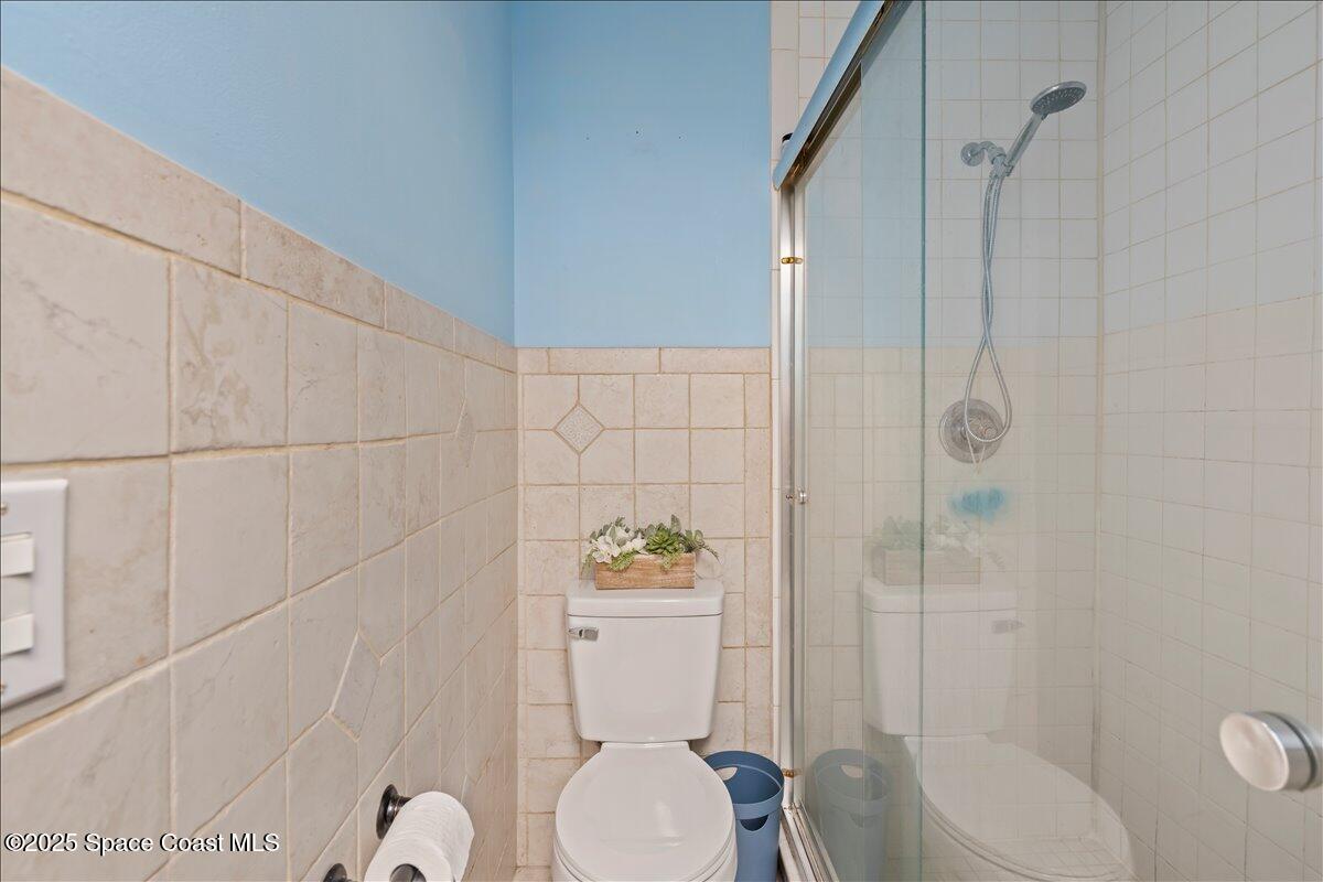 199 Florida A1A, Unit D201 Satellite Beach, FL 32937 - Photo 25 of 39 a bathroom with a toilet and a shower