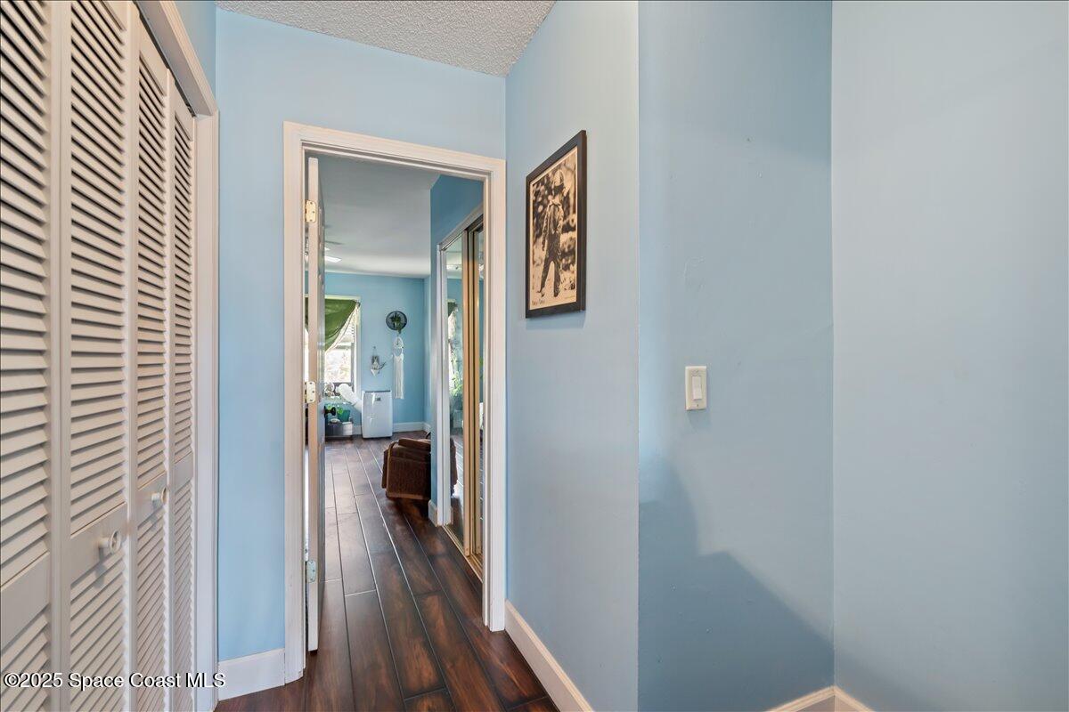 199 Florida A1A, Unit D201 Satellite Beach, FL 32937 - Photo 26 of 39 a view of a hallway with wooden floor