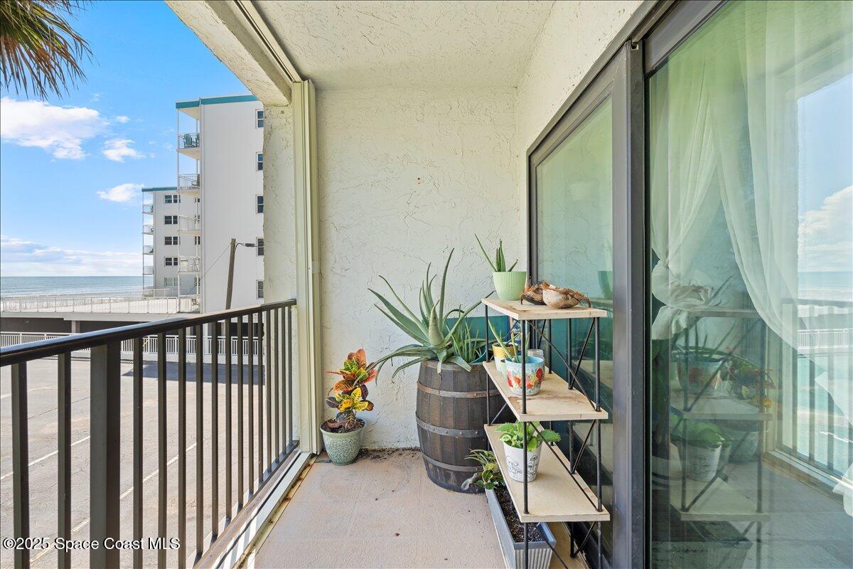 199 Florida A1A, Unit D201 Satellite Beach, FL 32937 - Photo 32 of 39 a balcony with furniture and a potted plant