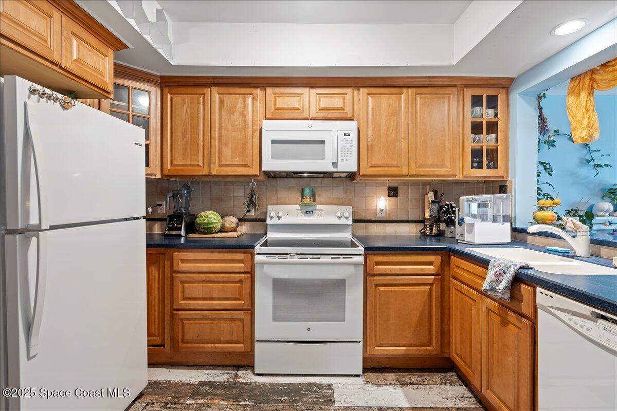 199 Florida A1A, Unit D201 Satellite Beach, FL 32937 - Photo 6 of 39 a kitchen with a refrigerator sink and cabinets