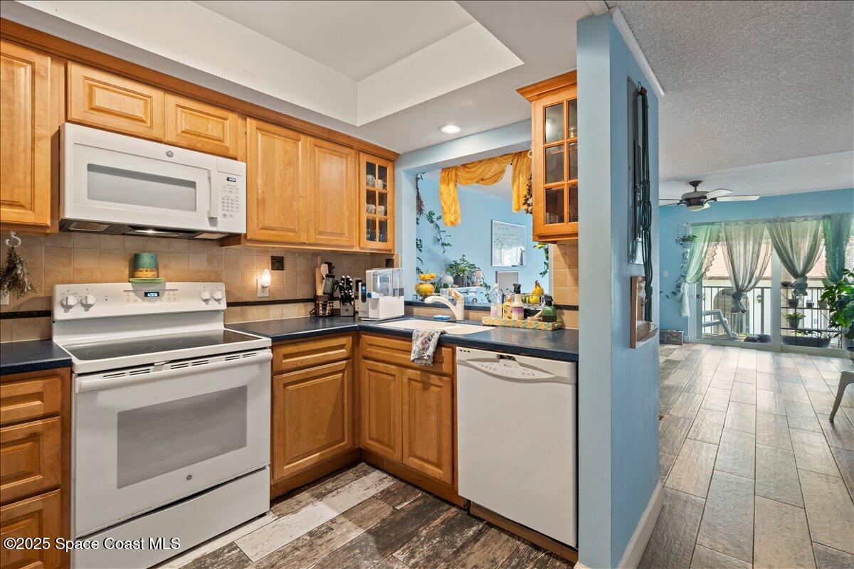 199 Florida A1A, Unit D201 Satellite Beach, FL 32937 - Photo 8 of 39 a kitchen with stainless steel appliances granite countertop a stove a sink and a refrigerator