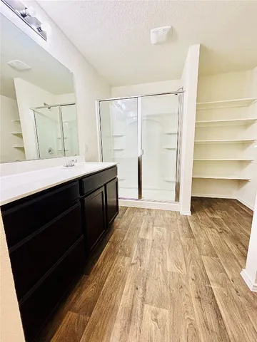 a view of empty room with wooden floor and window