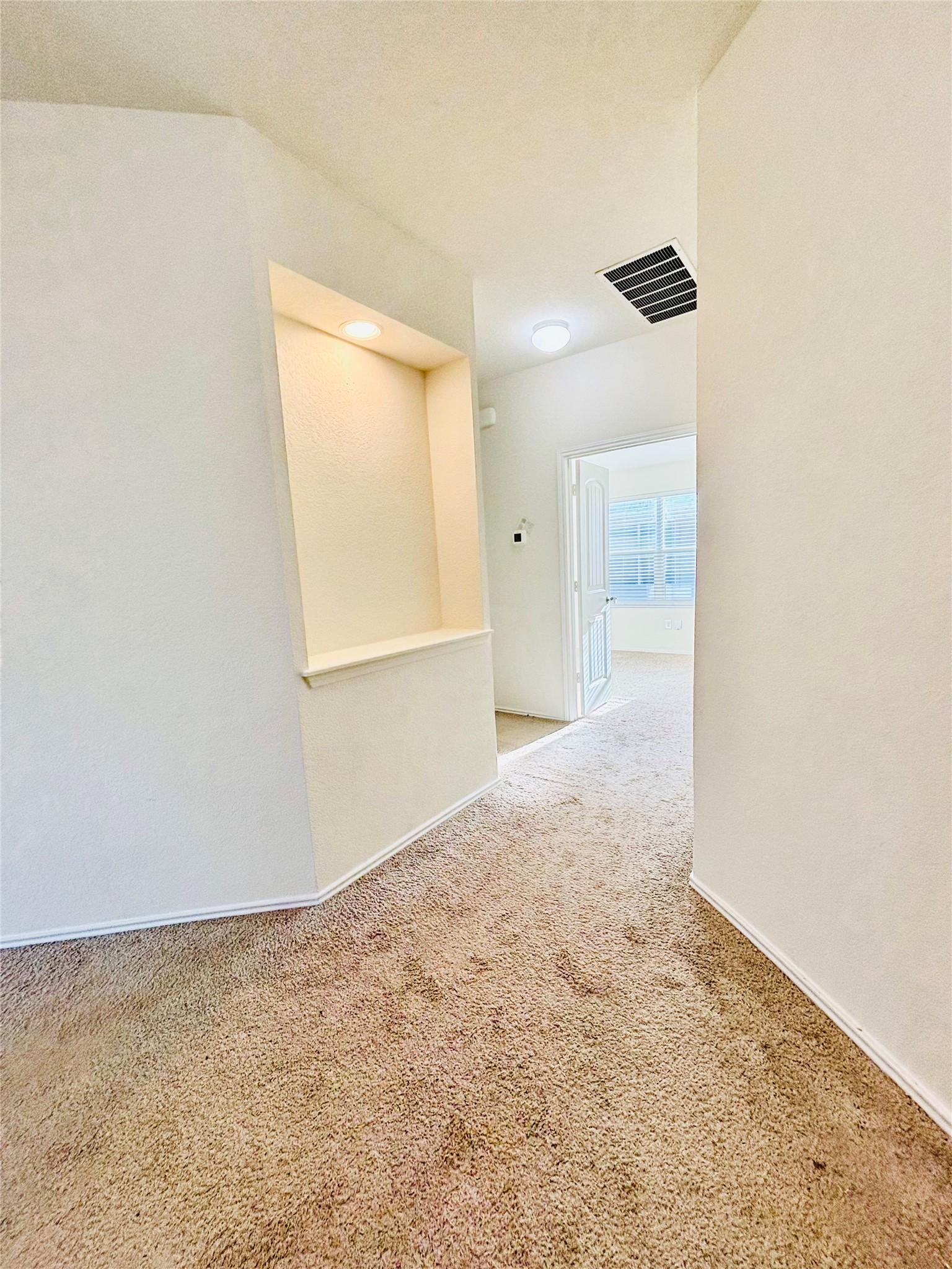 15125 Harkness Pass Austin, TX 78725 - Photo 9 of 23 an empty room with a window and wooden floor