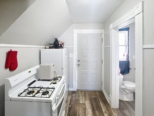 a kitchen with a refrigerator and a stove