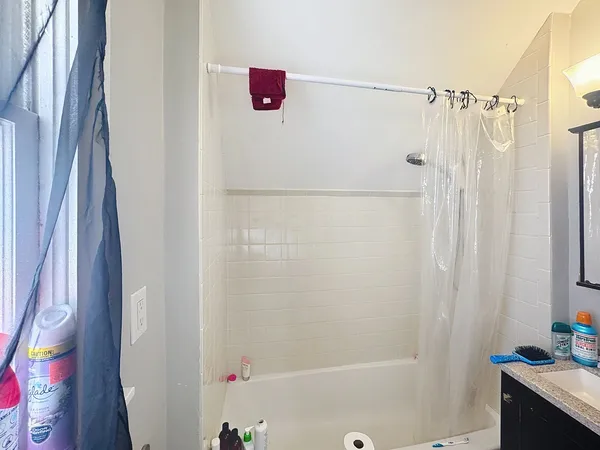 a bathroom with a shower and a sink