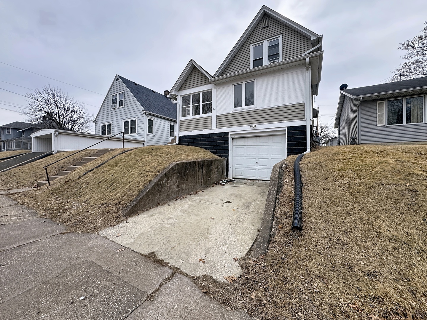 2748 11th Avenue Moline, IL 61265 - Photo 2 of 16 a front view of a house with a yard and garage