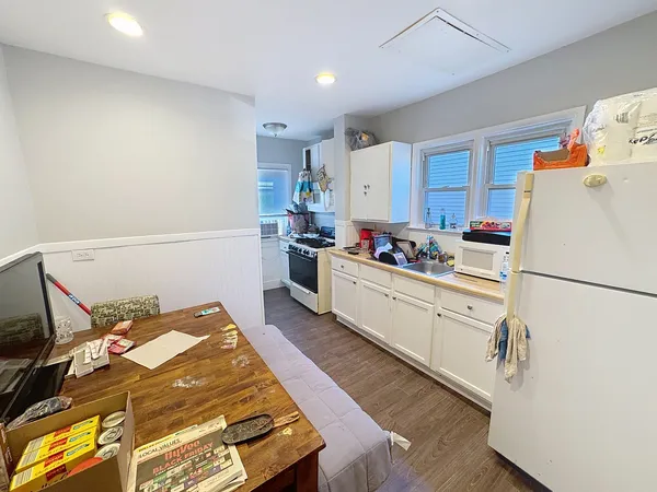 a kitchen with stainless steel appliances a refrigerator sink and cabinets