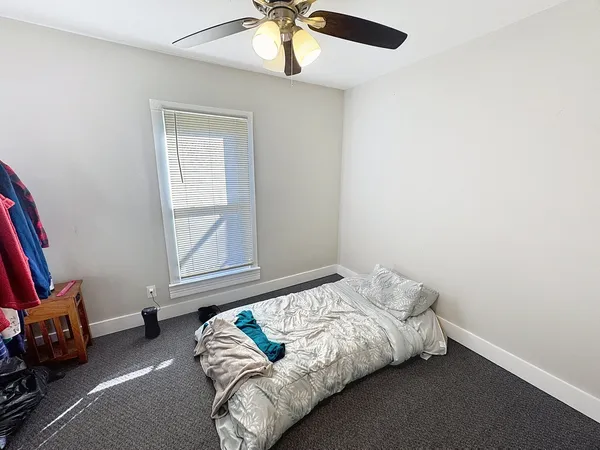 a bedroom with bed and a window