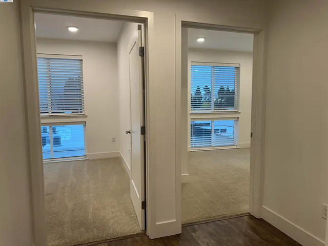 an empty room with wooden floor and a window