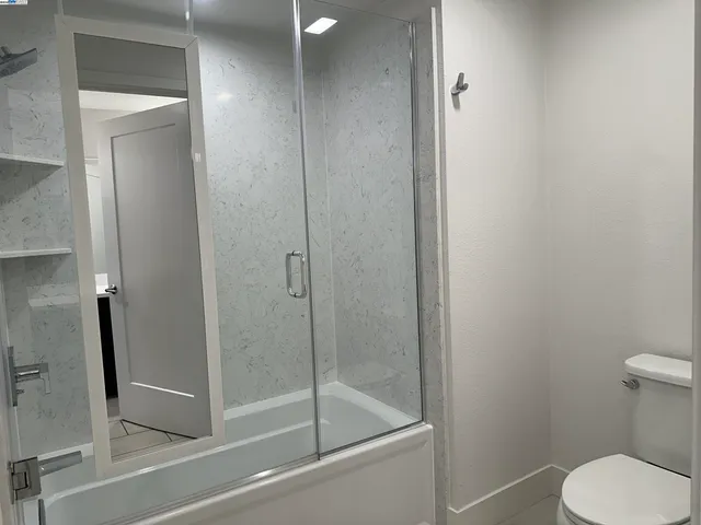 a bathroom with a shower and toilet