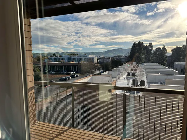 a view of a balcony with floor to ceiling windows yard