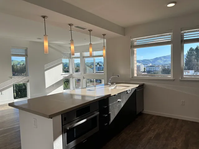 a kitchen with granite countertop a stove and a sink