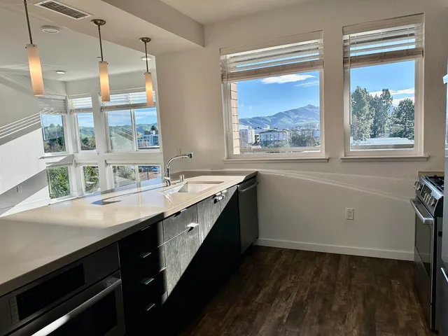 a kitchen with a sink stove and cabinets
