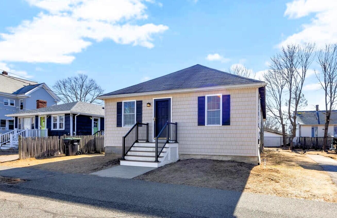 44 Holmes Road Dedham, MA 02026 - Photo 1 of 24 a front view of a house with a yard