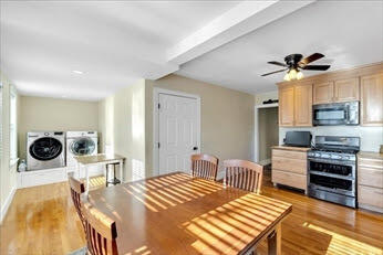 44 Holmes Road Dedham, MA 02026 - Photo 11 of 24 a bedroom with a bed and a chandelier