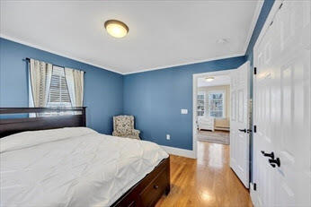 44 Holmes Road Dedham, MA 02026 - Photo 15 of 24 a bedroom with a bed and a cabinets