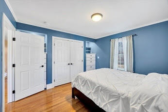 44 Holmes Road Dedham, MA 02026 - Photo 16 of 24 a bedroom with a bed and a window