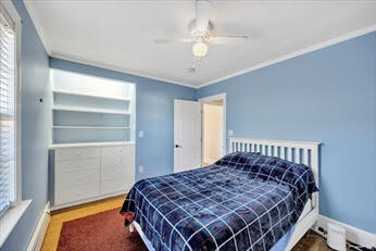 44 Holmes Road Dedham, MA 02026 - Photo 21 of 24 a bedroom with a bed and a chandelier