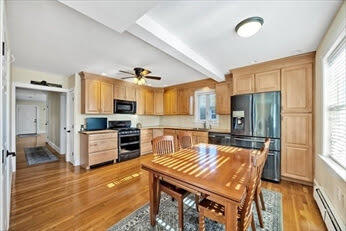 44 Holmes Road Dedham, MA 02026 - Photo 10 of 24 a kitchen with a stove a refrigerator and a stove top oven