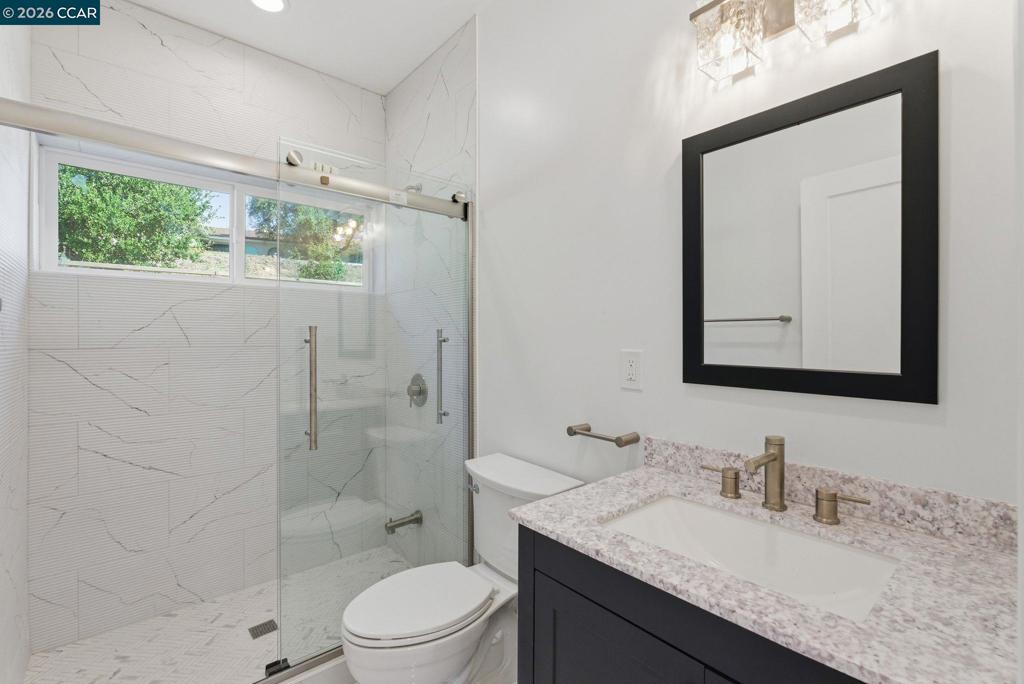 3196 Rohrer Drive Lafayette, CA 94549 - Photo 18 of 30 a bathroom with a granite countertop sink toilet a mirror and shower