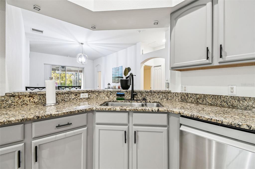 11478 Weston Course Loop Riverview, FL 33579 - Photo 14 of 30 a kitchen with granite countertop stainless steel appliances sink and cabinets