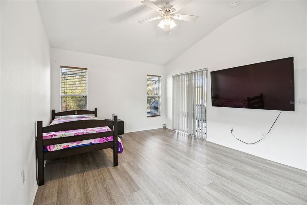 11478 Weston Course Loop Riverview, FL 33579 - Photo 16 of 30 a bedroom with a bed and a flat screen tv