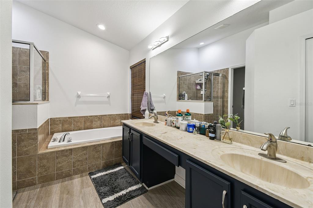 11478 Weston Course Loop Riverview, FL 33579 - Photo 19 of 30 a bathroom with a double vanity sink a mirror and bathtub