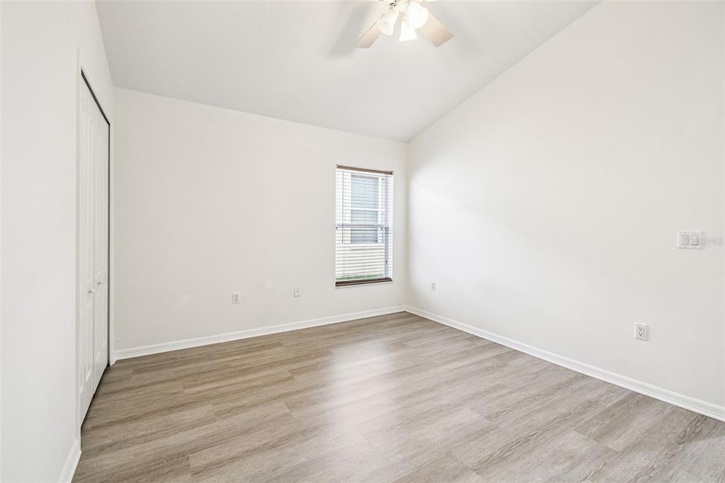 11478 Weston Course Loop Riverview, FL 33579 - Photo 21 of 30 an empty room with wooden floor and windows