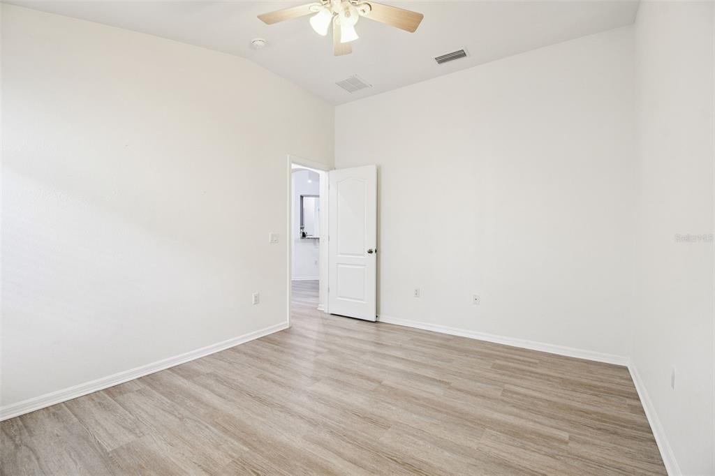 11478 Weston Course Loop Riverview, FL 33579 - Photo 22 of 30 an empty room with wooden floor and fan