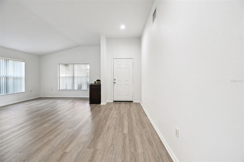 11478 Weston Course Loop Riverview, FL 33579 - Photo 7 of 30 an empty room with wooden floor and windows