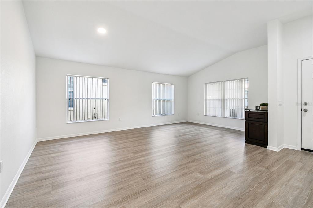 11478 Weston Course Loop Riverview, FL 33579 - Photo 8 of 30 a view of empty room with wooden floor and fan